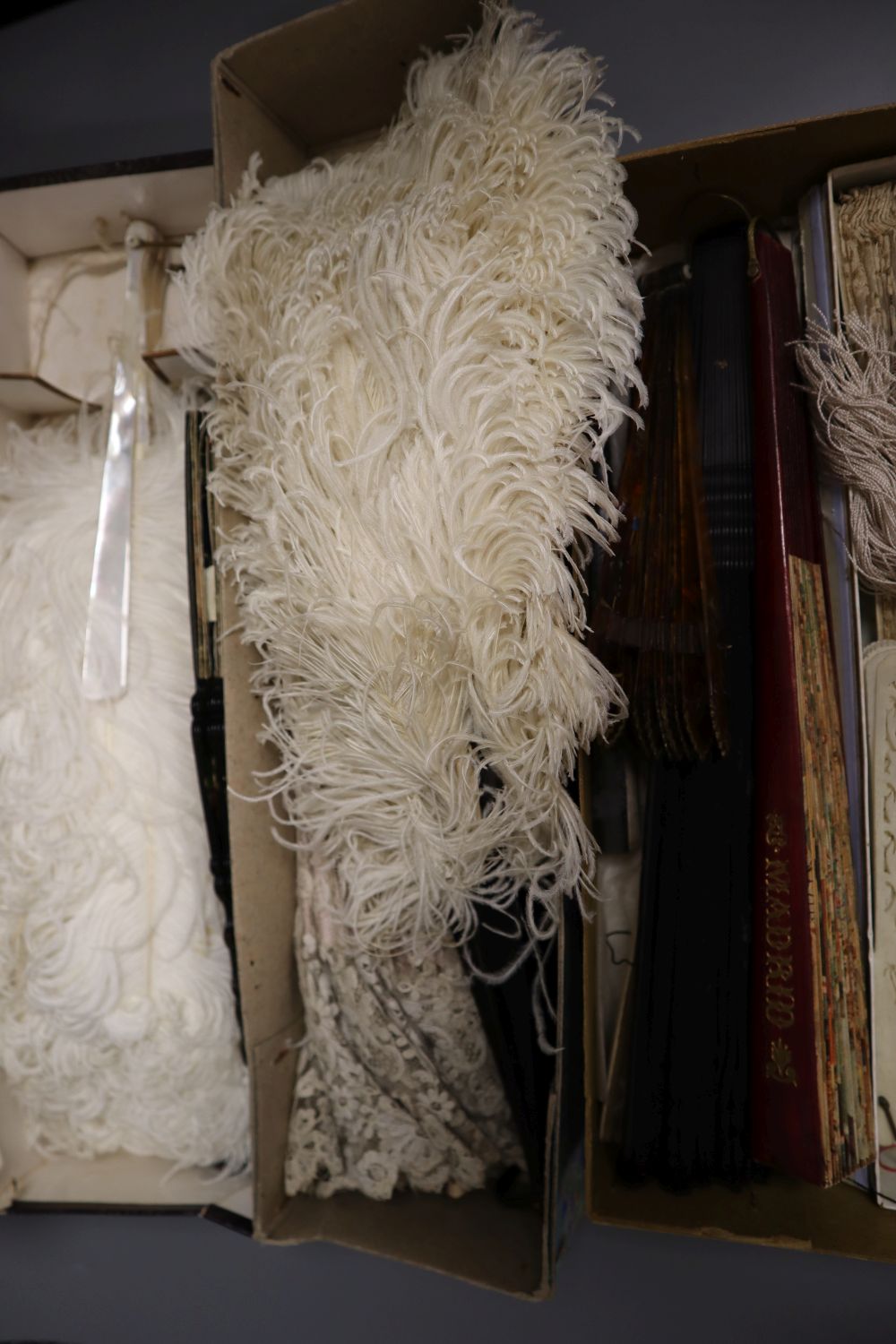 A collection of fans and a lace parasol